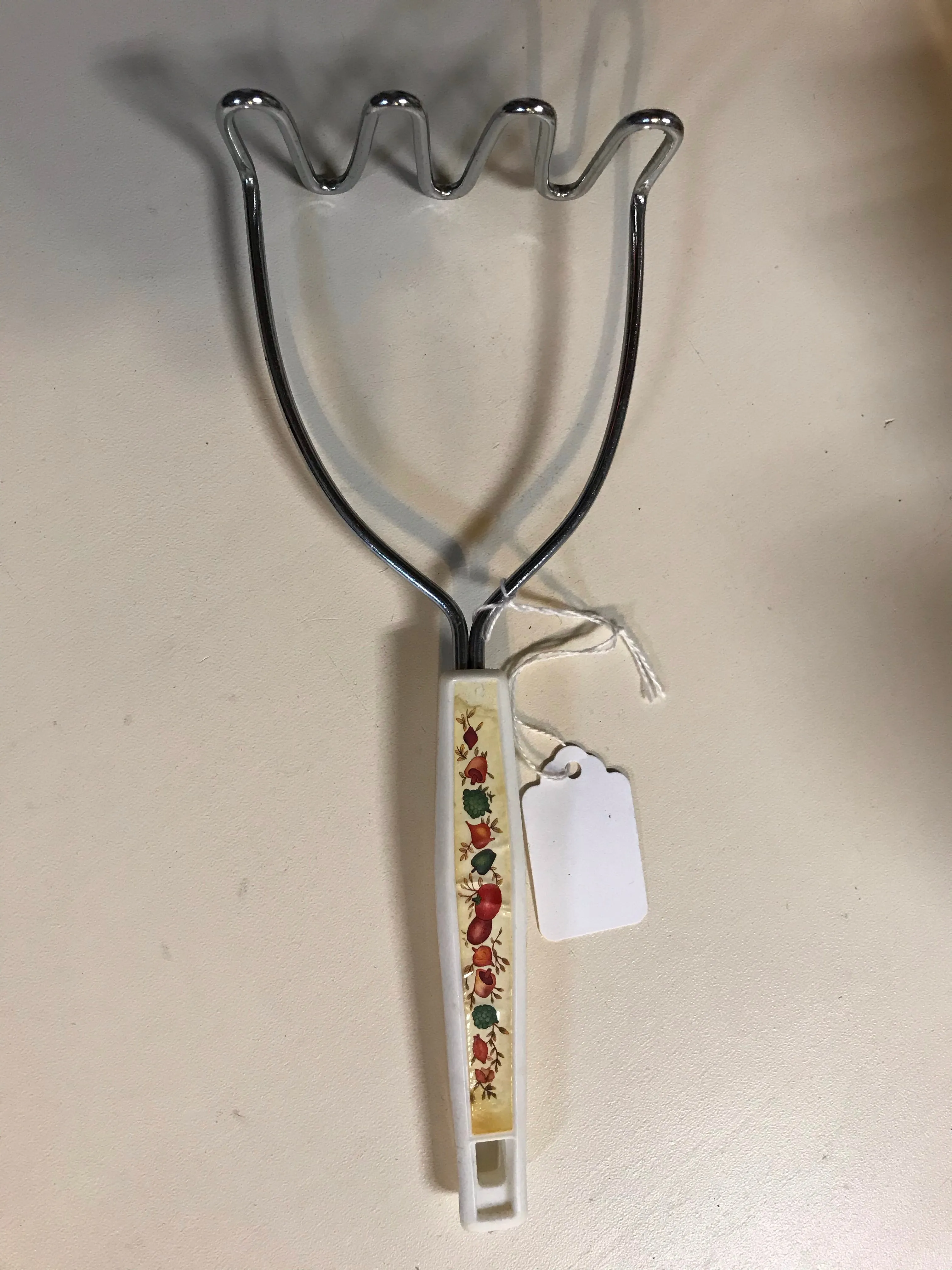 <€€ Vintage Stainless 9.5" Potato Masher White Handle with Vegetable Design